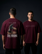 Still Here. Still Building — Oversized Tee